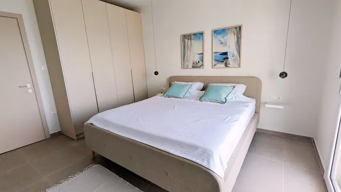 Bedroom with large bed and blue pillows