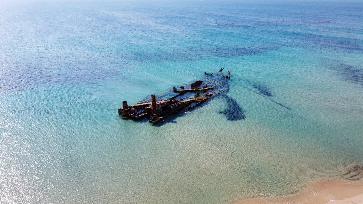 The Epanomi shipwreck in turquoise water off Potamos Beach