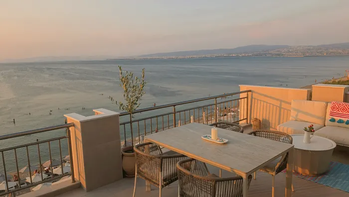 Terrace lounge and dining area in golden-hour light