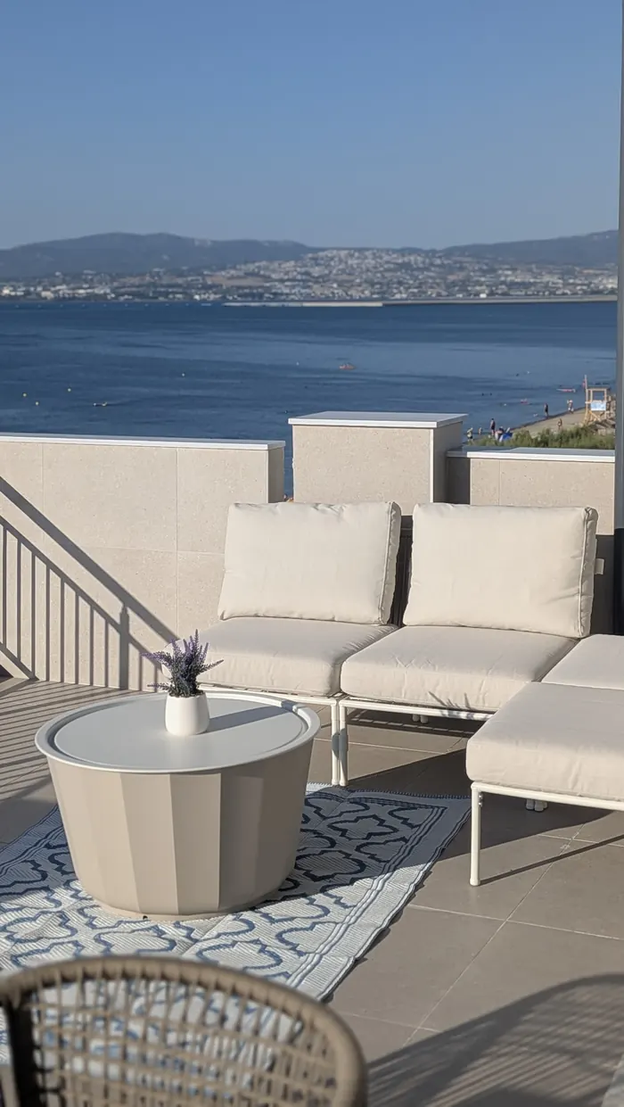 Outdoor lounge sofa on the terrace with Thessaloniki across the bay